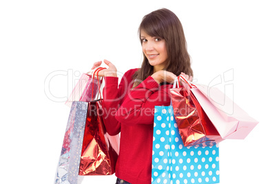 Smiling brunette holding shopping bags