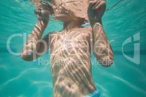 Cute kid posing underwater in pool