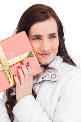 Portrait of a pretty brunette holding gift