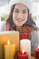 Portrait of pretty brunette behind candles