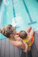 Pretty mother and baby at the swimming pool