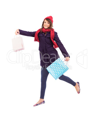 Festive brunette holding shopping bags