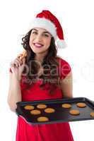 Festive brunette eating hot cookies