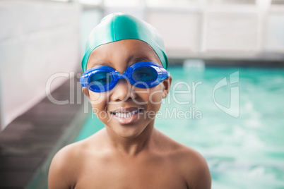 Cute little boy smiling at the pool