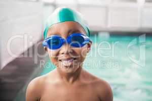 Cute little boy smiling at the pool