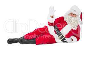 Relaxed santa lying and waving