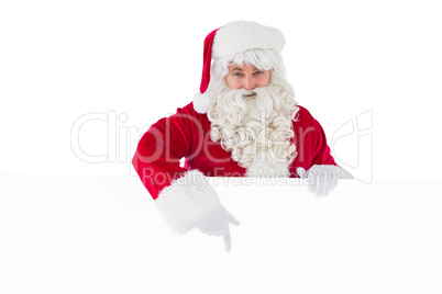 Joyful santa claus presenting sign