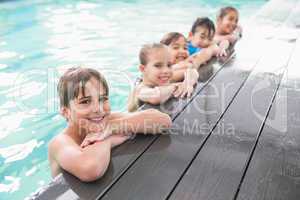 Cute swimming class in the pool