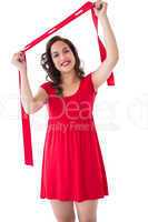 Happy brunette in red dress holding scarf