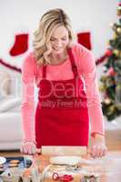 Festive blonde making christmas cookies