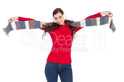 Cheerful brunette holding scarf and spread her arms