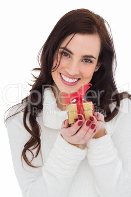 Portrait of a brunette holding gild gift