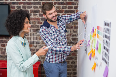 Team looking at sticky notes on wall