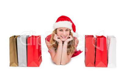 Smiling woman lying between shopping bags