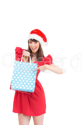 Festive brunette holding a gift bag