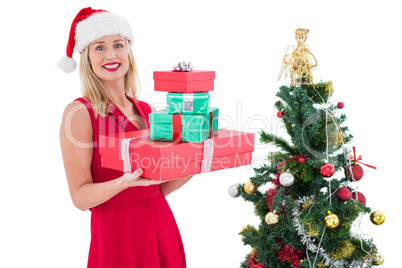 Festive blonde in red dress holding gifts