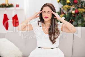 Brunette getting a headache on christmas day