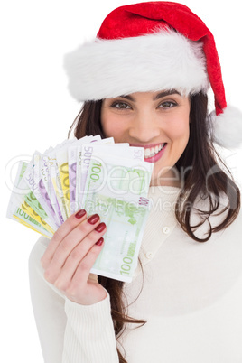 Festive brunette holding her cash