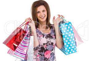 Smiling young woman holding shopping bags