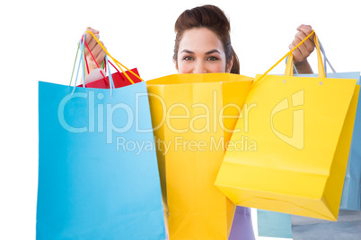 Happy brunette opening shopping bags