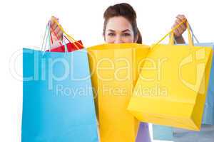 Happy brunette opening shopping bags