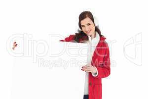 Happy brunette showing white poster