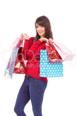 Happy brunette holding shopping bags