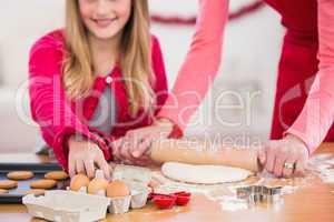 Festive mother and daughter making christmas cookies