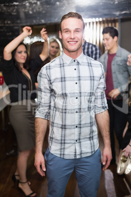 Stylish man smiling on the dancefloor