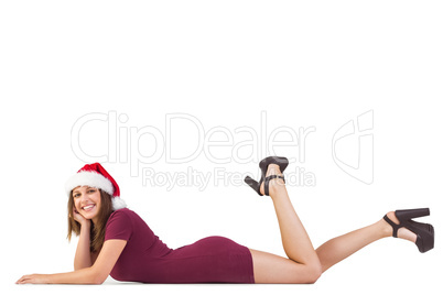 Festive brunette smiling at camera while lying