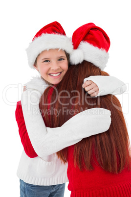 Festive mother giving daughter a hug