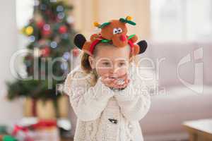 Festive little girl blowing over hands