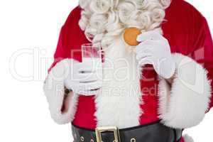 Santa holding glass of milk and cookie