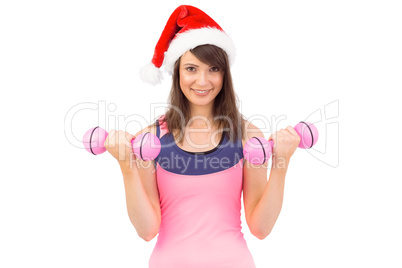 Woman in santa hat holding hand weight