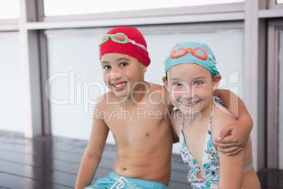 Cute little kids sitting poolside