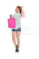 Woman carrying shopping bags over her shoulder