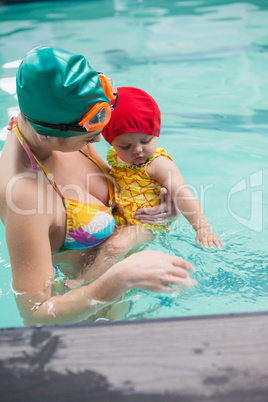 Pretty mother and baby at the swimming pool