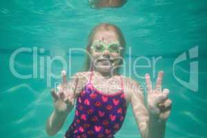 Cute kid posing underwater in pool