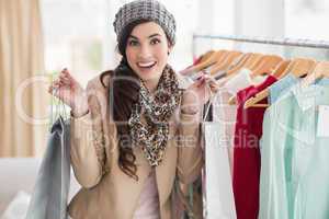 Pretty brunette holding shopping bags