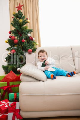 Cute baby boy on couch at christmas