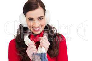Happy brunette in winter clothes smiling at camera