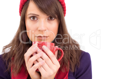 Serious young woman holding a mug