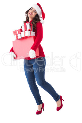 Happy brunette holding many gifts