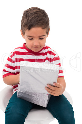 Cute little boy opening gift