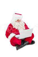 Santa sitting and using his laptop