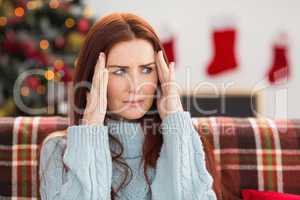Woman getting a head ache at christmas