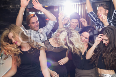 Stylish friends dancing and smiling