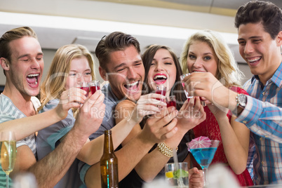 Happy friends having a drink together