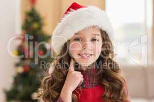 Festive little girl thinking and smiling