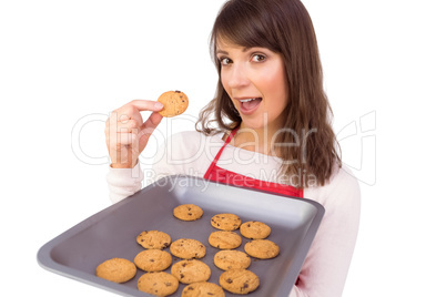 Festive brunette showing hot cookies